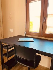 a desk with a laptop sitting on top of it at Buhardilla con encanto in Ontinyent +6 photos