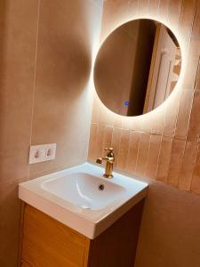 a bathroom with a sink and a mirror at Buhardilla con encanto in Ontinyent
