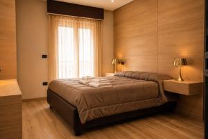 a bedroom with a large bed with a window at ALMA ROOM in Santa Maria Capua Vetere