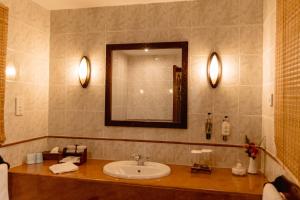 a bathroom with a sink and a mirror at Arusha Serena Hotel in Tengeru
