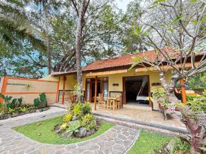 a house with a table and chairs in front of it at Alam Mimpi Bali in Tejakula