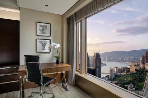 a room with a desk and a large window at Kempinski Hotel Chongqing in Chongqing