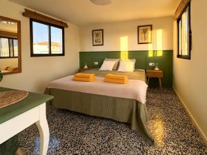 a bedroom with a bed with two orange towels on it at Sunset Terrace Studio - Ocean View - Top Floor in Buenavista del Norte