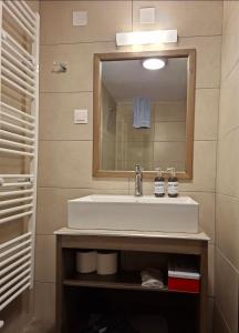 a bathroom with a sink and a mirror at Ονειρόπετρα 2 in Mouzaki +16 photos