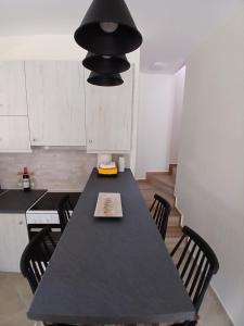 a black table in a kitchen with a black light fixture at Vytina maisonette in Vitina +17 photos