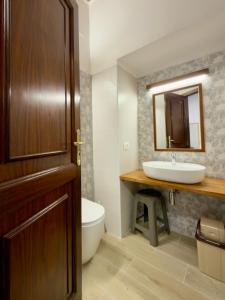 a bathroom with a sink and a toilet and a mirror at Vin e Turn in Diamante
