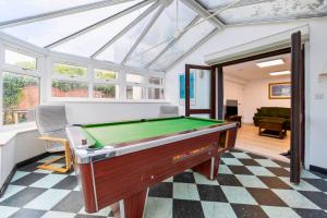 a living room with a pool table in it at The Elements Residence in Chepstow