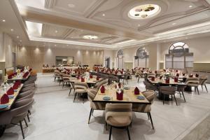 a restaurant with tables and chairs in a room at Treat Imperial Aurangabad City Center in Aurangabad