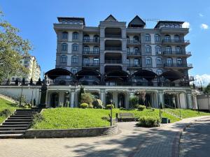 a large white building with a staircase in front of it at Апарт-готель номер 303 in Truskavets