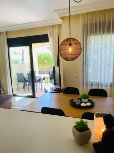 a living room with a dining room table and a dining room at Townhouse overlooking the pool in San Javier