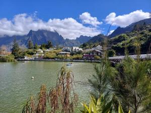 a lake with a town and mountains in the background at La Kaz Eden * * * * in Les Cocos