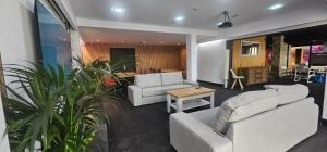 a living room with two white couches and a table at Grupo Izarbe, HOTEL ELLAURI in Zeanuri