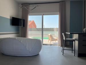 a living room with a white couch in front of a sliding glass door at Mirror Villas in Dhorizáta +81 photos