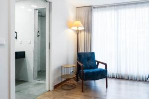 a room with a blue chair and a glass shower at Hotel Vice-Rei in Porto +108 photos