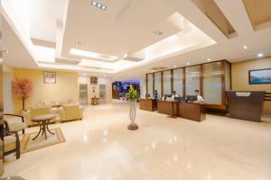 an office lobby with people working at computers at MGM Mark Whitefield in Bangalore