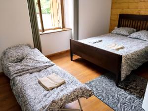 a bedroom with two beds and a window at Pyrenean Pursuits in Biert