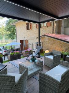 an outdoor patio with wicker chairs and a table at Villa dei Macchini in Chiusi della Verna