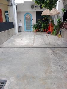 a building with a blue door and an umbrella at Le Melur in George Town