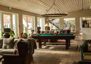 a living room with a pool table and couches at Elisefarm in Fogdarp
