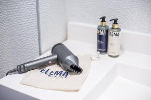 a blow dryer sitting on top of a bathroom sink at L'Univers Arras by Elema Hotels ex Hôtel de l'Univers Arras in Arras