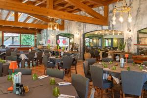 a dining room with tables and chairs at West Garda Hotel in Padenghe sul Garda