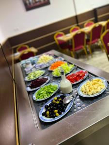 a buffet with plates of food on a table at Hôtel Telemly - Chaine El Djazair in Alger