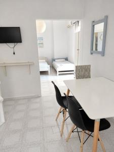 a living room with a white table and chairs at Galatas home in Galatas