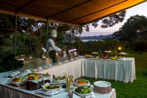 a table with a buffet of food on it at Arusha Serena Hotel in Tengeru +27 photos