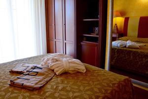 a pile of towels sitting on top of a bed at AmbientHotels Panoramic in Rimini