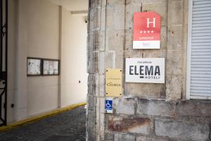 a brick wall with signs on the side of a building at L'Univers Arras by Elema Hotels ex Hôtel de l'Univers Arras in Arras