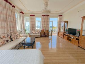 a large living room with a bed and a television at AN Apartment in Danang
