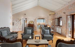 a living room with chairs and a table at Pirgos Petropoulea in Poliána