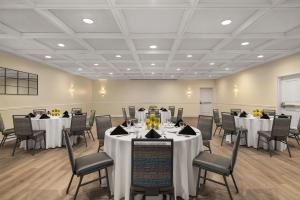 a banquet room with tables and chairs with white tablecloths at DoubleTree Suites by Hilton Melbourne Beach Oceanfront in Melbourne +40 photos