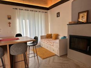 a bedroom with a bed and a table and a fireplace at Blue Moon in Zărneşti