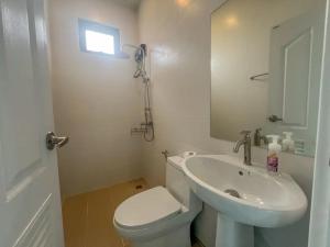 a bathroom with a sink and a toilet and a mirror at Indigo Garden Villa by Somjai in Ban Tha Fat