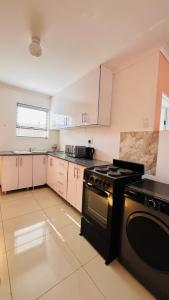 a large kitchen with a stove top oven in it at Khopolong Estates in Berea Hills +30 photos
