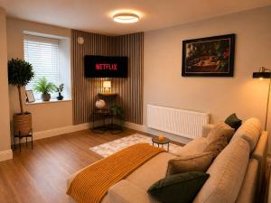 a living room with a couch and a window at The Viking Townhouse - Heart of Waterford in Waterford