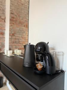 a coffee maker sitting on a black counter top at GRATIA RESIDENCE Lublin in Lublin