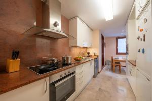 a kitchen with a sink and a stove top oven at Can Jeroni in Figueres