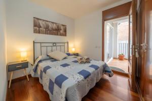 a bedroom with a bed with a teddy bear on it at Can Jeroni in Figueres