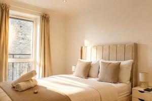 a bedroom with a large bed with a window at Luxury Flat close to City Centre & Docks in Southampton