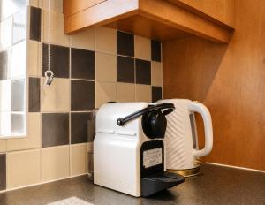 a coffee maker sitting on a counter in a kitchen at Luxury Flat close to City Centre & Docks in Southampton +13 photos