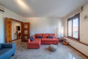 a living room with a red couch and a large window at Can Jeroni in Figueres