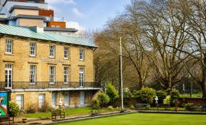 a large brick building with a green roof at Luxury Flat close to City Centre & Docks in Southampton