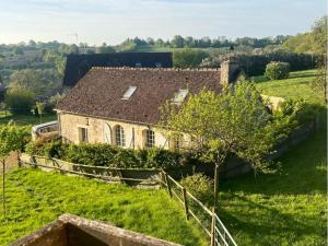 an old house on a hill in a field at Haras du Chêne in Colonard-Corubert