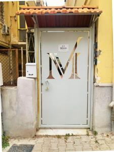 a white garage door with a sign on it at B&B VMHome in Torre del Greco