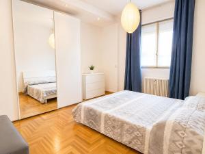 a bedroom with two beds and a large mirror at The Charme - Modern Apartment in Como with Balcony in Como