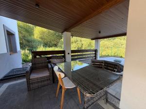 a patio with a table and chairs on a deck at Alpine in Skhidnitsa