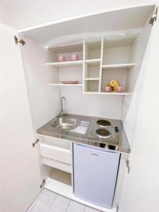 a small kitchen with a sink and a stove at B&B VMHome in Torre del Greco