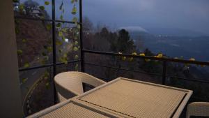a table and chairs on a balcony with a view at Murree best apartment in Murree